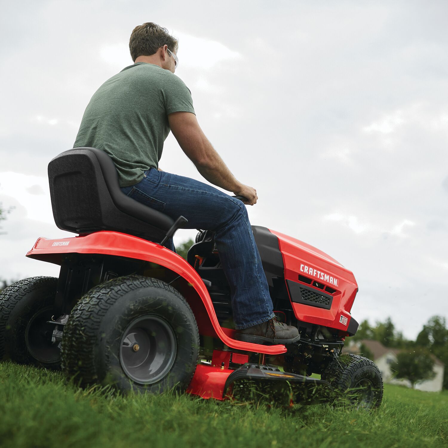 Owner mowing a lawn with the CRAFTSMAN T110